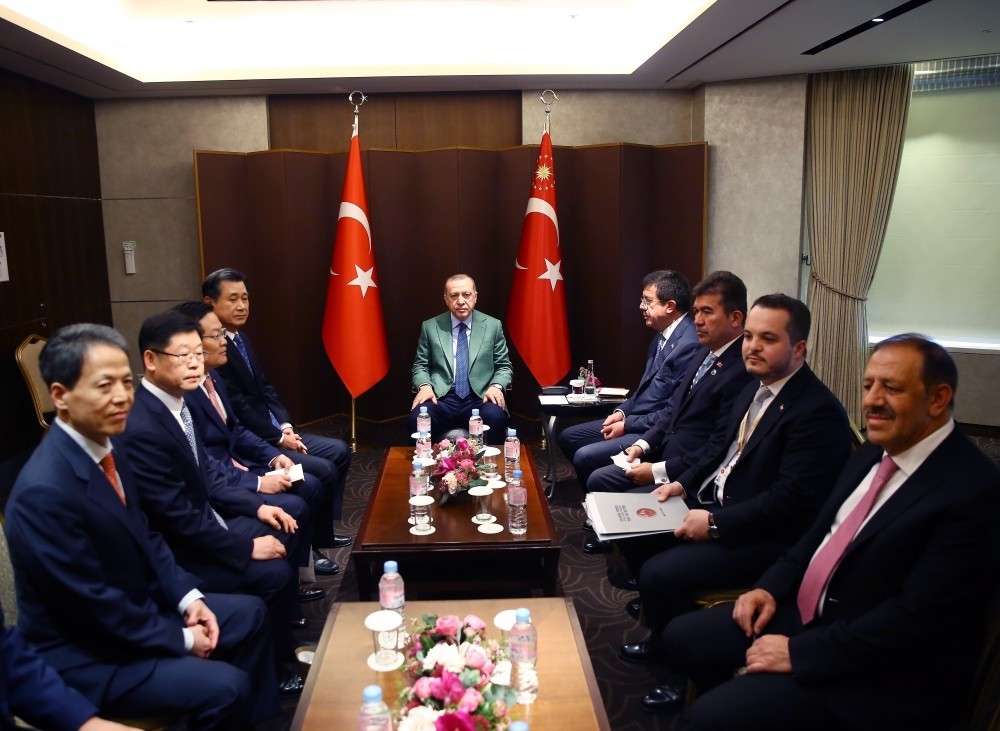 President Erdou011fan (C) met the executives of South Korean Hanwha Q-cellls during his two-day visit in the country, Seoul, May 3.