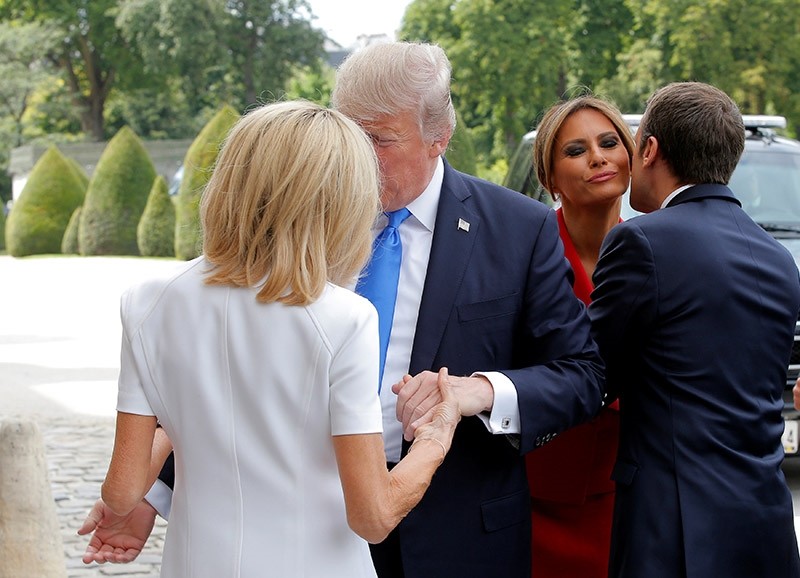French President Emmanuel Macron (R) greets U.S. First Lady Melania Trump while his wife Brigitte Macron (L) welcomes U.S. President Donald Trump at Les Invalides museum in Paris, France, July 13, 2017. (Reuters Photo)