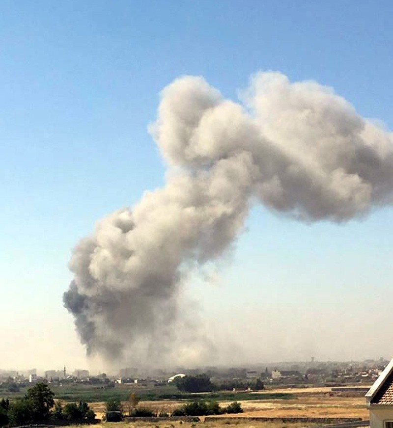 This photo captured from the town of Nusaybin near the Turkish side of the border shows plume of smoke occurred after the explosion. (IHA Photo)