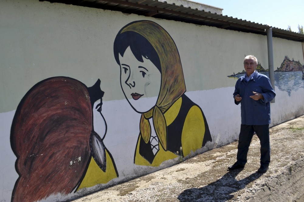 Mustafa Toga started to paint the exterior wall of his house two years ago. Later, he painted many figures on the walls of other houses in the neighborhood.