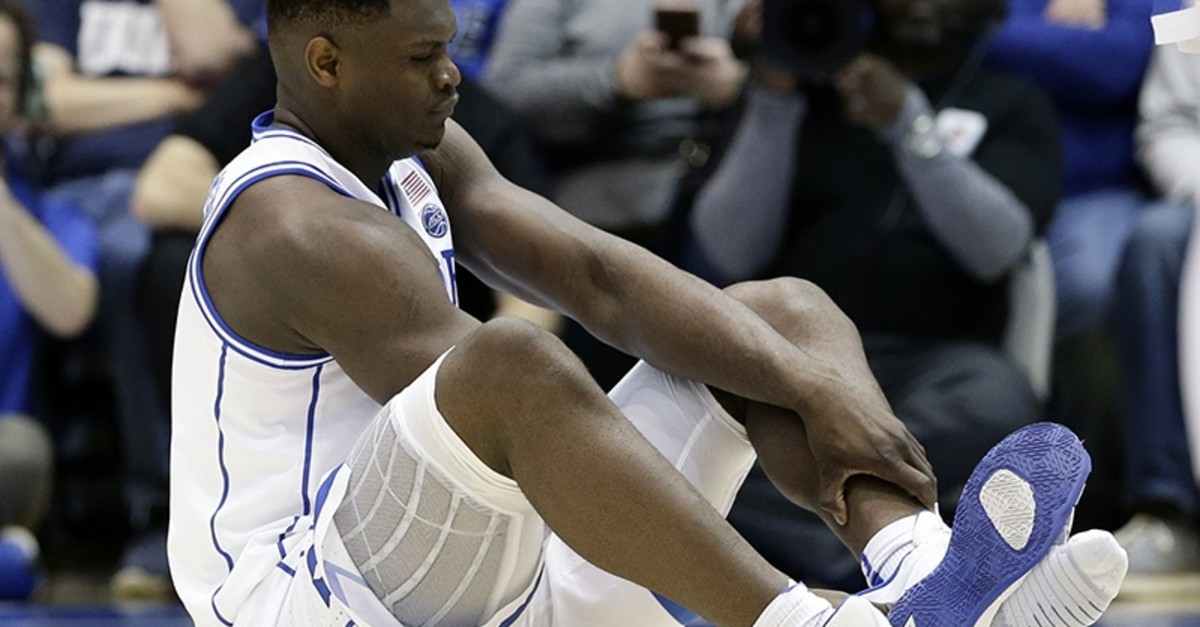 Duke's Zion Williamson sits on the floor following an injury during the first half of an NCAA college basketball game against North Carolina, in Durham, N.C., Wednesday, Feb. 20, 2019. (AP Photo)