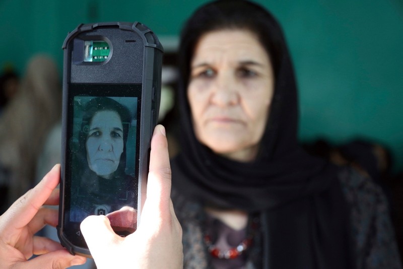  In this Oct. 20, 2018 file photo, a woman poses for a picture, taken by an election official, before casting her vote in the Parliamentary election, in Kabul, Afghanistan (AP Photo)