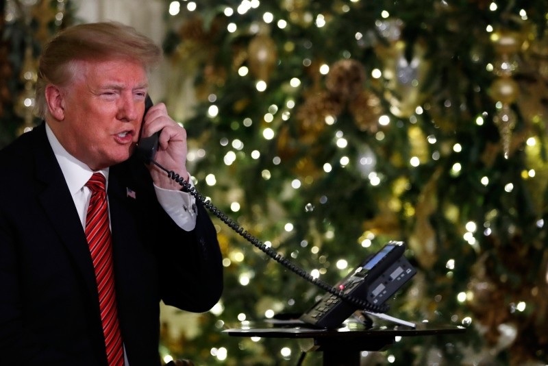 President Donald Trump speaks on the phone sharing updates to track Santa's movements from the North American Aerospace Defense Command (NORAD) Santa Tracker on Christmas Eve, Monday, Dec. 24, 2018. (AP Photo)