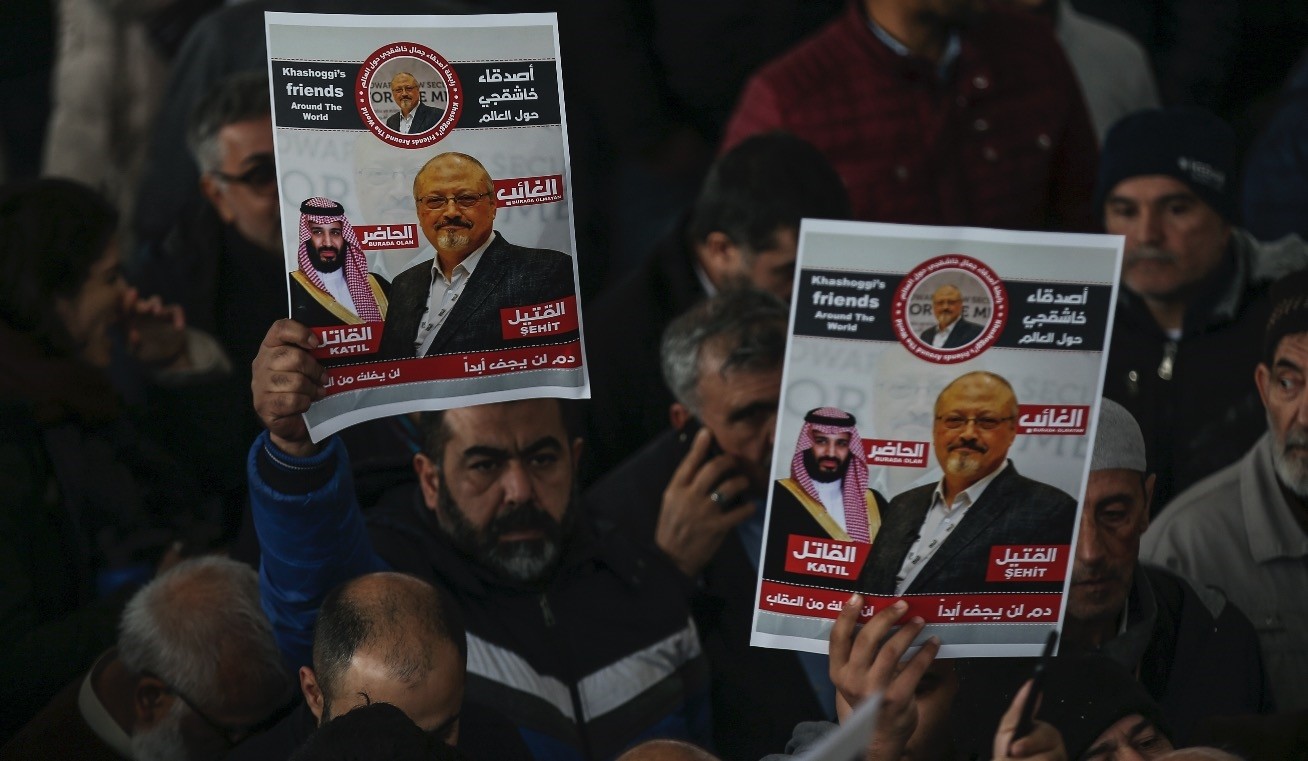 People hold posters as they attend funeral prayers in absentia for Saudi writer Jamal Khashoggi who was killed last month in the Saudi Consulate in Istanbul, Nov. 16.