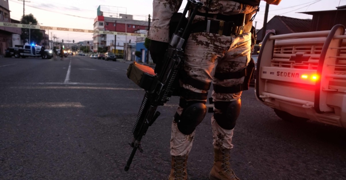 Mexican Soldiers guard a crime scene where a man was killed by gun fire in downtown Tijuana, Baja California state, Mexico, on April 21, 2019 (AFP Photo)