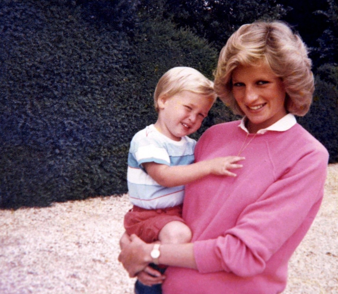 Princess Diana holding Prince William.