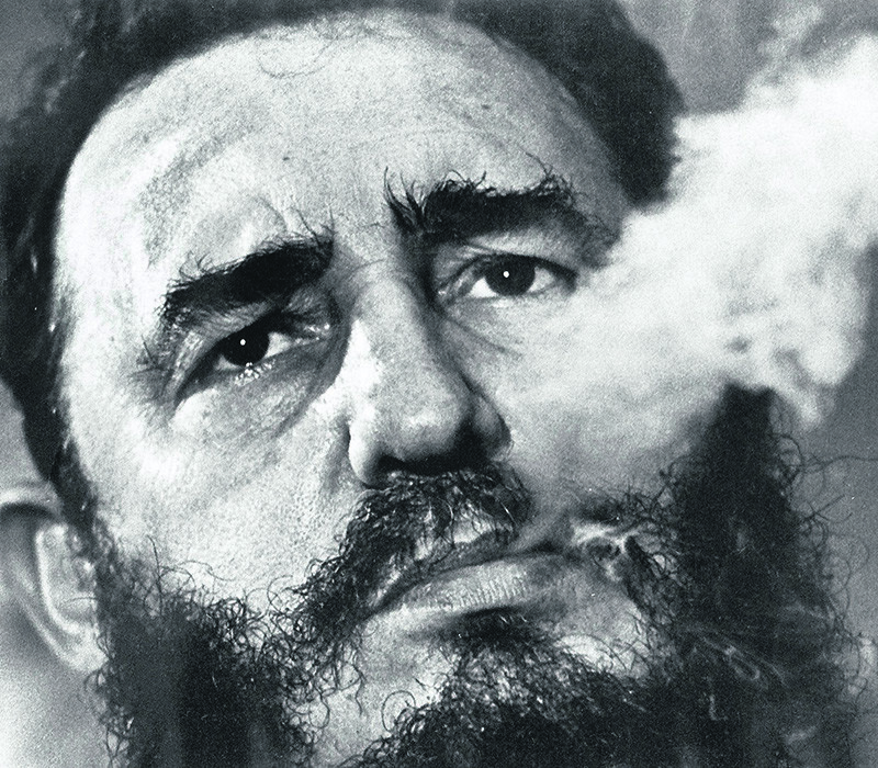 In a file photo  Fidel Castro exhales cigar smoke during a March 1985 interview at his presidential palace in Havana. (AP Photo)