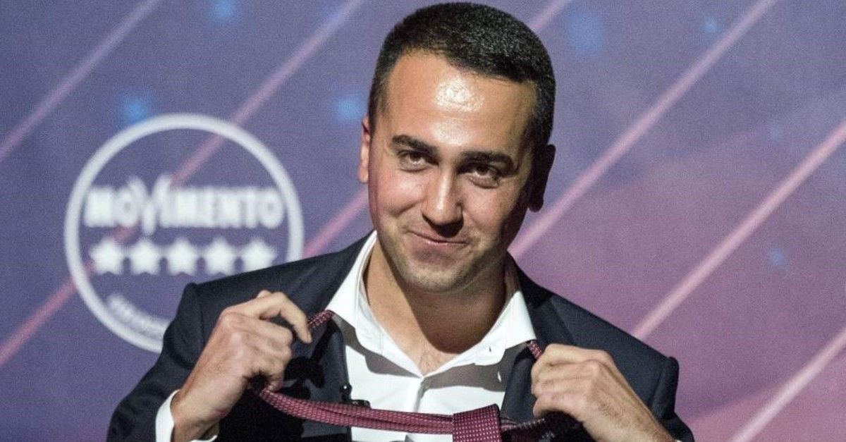 Italy's Foreign Minister and Five Star Movement leader Luigi Di Maio unfastens his tie at the end of his speech, Rome, Jan. 22, 2020. (AP Photo)