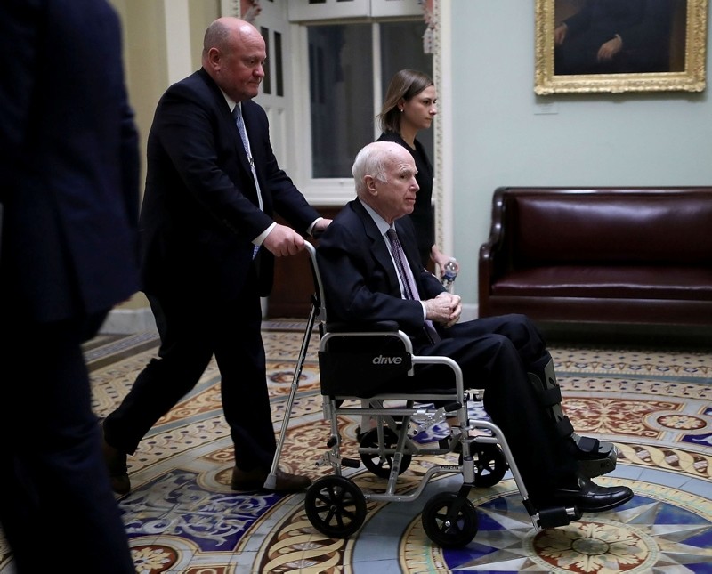 In this file photo taken on November 30, 2017, US Senator John McCain moves through the U.S. Capitol in a wheelchair in Washington, DC. (AFP Photo)