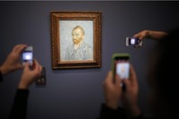 Visitors take pictures with their mobile phone of the painting ,Portrait de l'Artiste, 1889, (Self-Portrait) by artist Vincent van Gogh (1853-1890) at the Musee d'Orsay in Paris, France, July 28, 2015. 