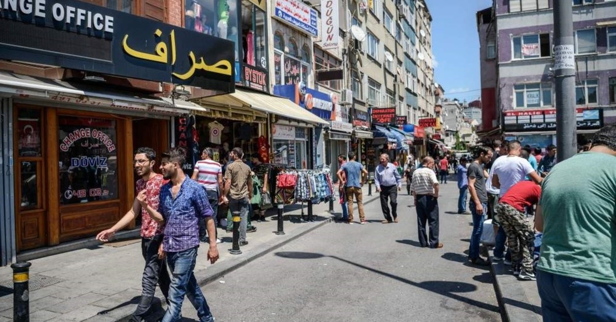 Syrian and Turkish people walk in a street next to shops with Arabic letters in Fatih district, Istanbul in this undated photo. (AFP Photo)