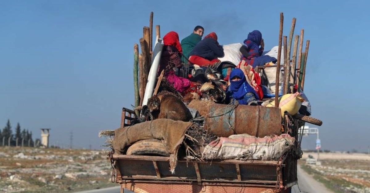 Displaced Syrians drive with their belongings as they flee airstrikes in Urum al-Sughra town in Syria's northwestern Aleppo province, Jan. 22, 2020. (AFP PHOTO)