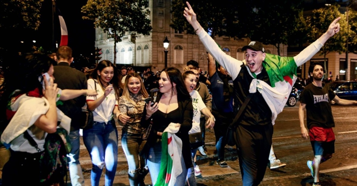 Algeria supporters celebrate after Algeria won the 2019 Africa Cup of Nations (CAN) semi-final football match against Nigeria, on the Champs-Elysee avenue in Paris, July 14, 2019. (AFP Photo)