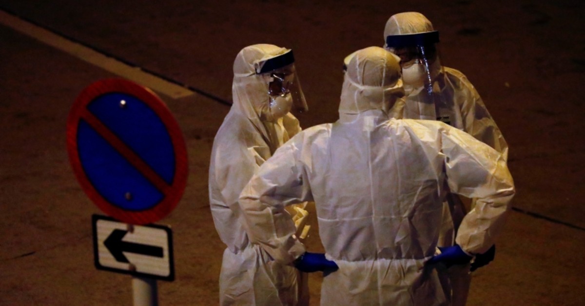 Personnel in protective gear prepare to evacuate residents from a public housing building following the outbreak of the novel coronavirus, in Hong Kong, China February 11, 2020. (Reuters Photo)
