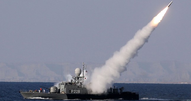 An Iranian navy warship test fires a new long range missile during the Iranian navy military exercise on the Sea of Oman, near the Strait of Hormuz in southern Iran.