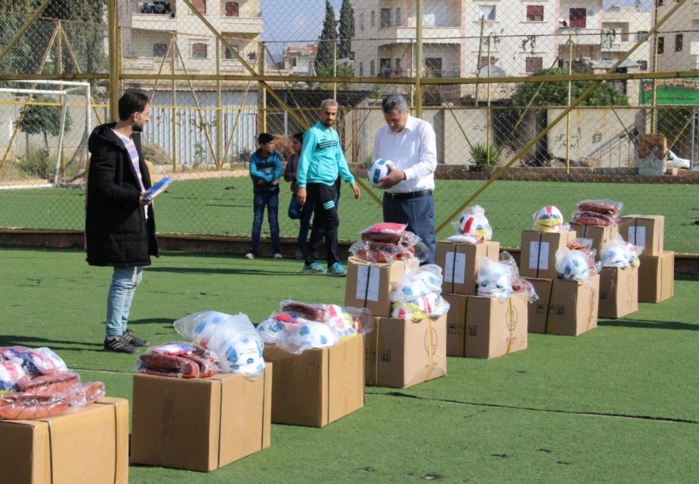 An official from Turkey's southern Hatay province distributes football and table tennis equipment as well as backpacks and jerseys to students in Afrin, Feb. 7, 2019.