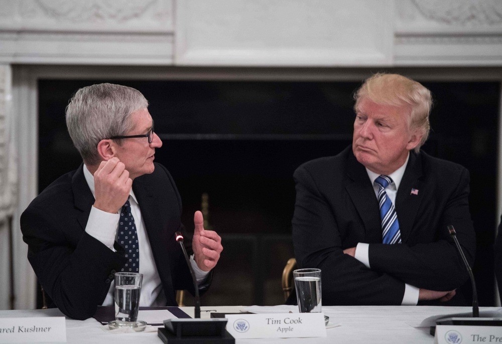 U.S. President Donald Trump listens to Apple CEO Tim Cook speak during an American Technology Council roundtable at the White House in Washington.