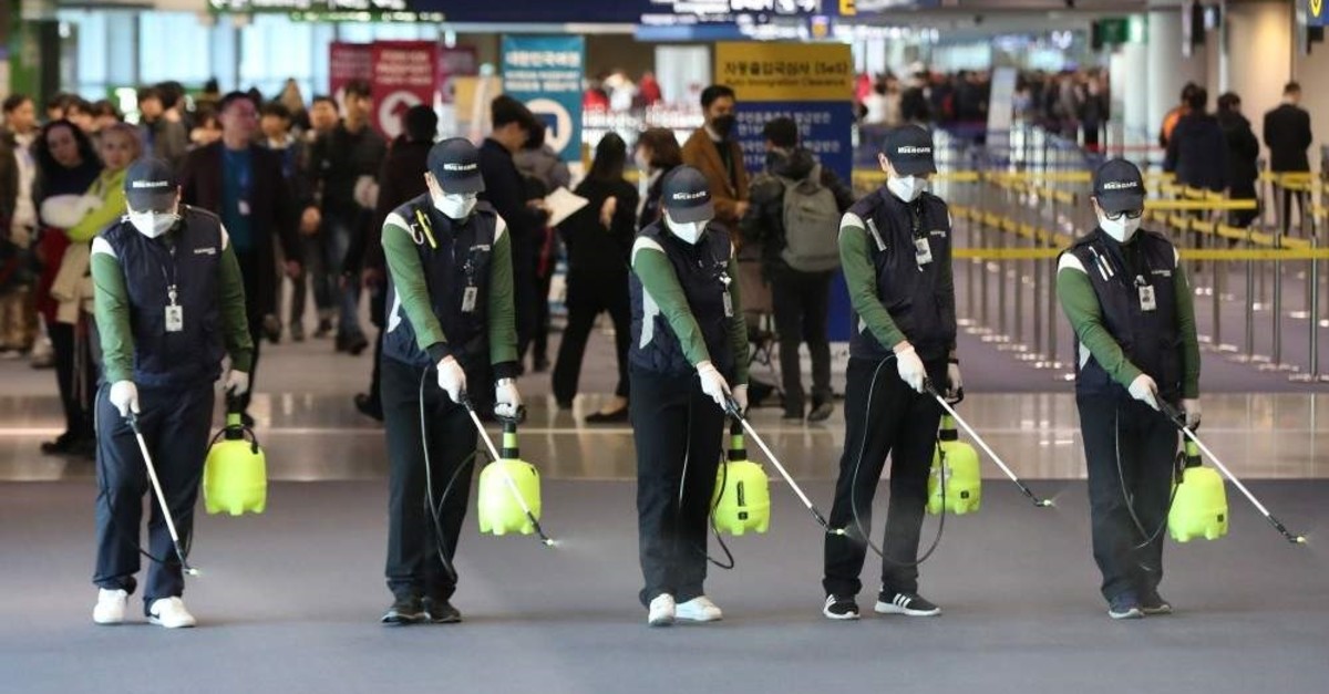 Workers from a cleaning service spray disinfectant at the customs, immigration and quarantine (CIQ) area at Incheon International Airport, Seoul, Jan. 21, 2020. (AFP Photo)