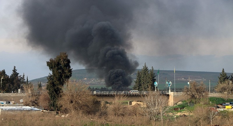 This photo shows smoke billowing from a tire fire, used by PKK-linked YPG terrorists to decrease ground visibility to Turkish jets circulating overhead, in the northern town of Afrin (AFP Photo)