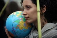 A demonstrator holds a terrestrial globe in Lisbon during a worldwide protest demanding action on climate change, Friday, Nov. 29, 2019. (AP Photo)
