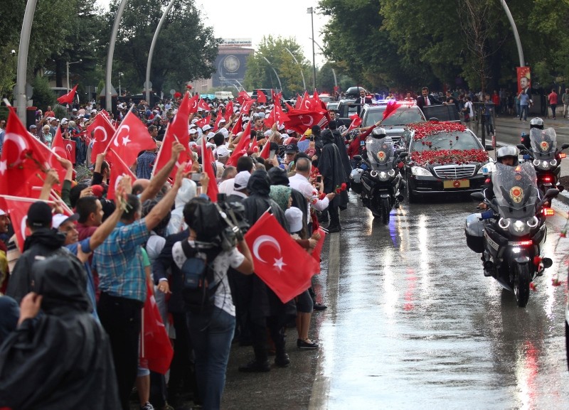 Supporters line the streets with Turkish flags as some throw flowers to the car of President Erdoğan on his way the mausoleum of the nation's founding father Mustafa Kemal Atatürk, in Ankara, Turkey, Monday, July 9, 2018.