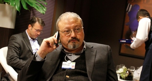 In this Jan. 29, 2011 photo, Saudi Arabian journalist Jamal Khashoggi speaks on his cellphone at the World Economic Forum in Davos, Switzerland. (AP Photo)