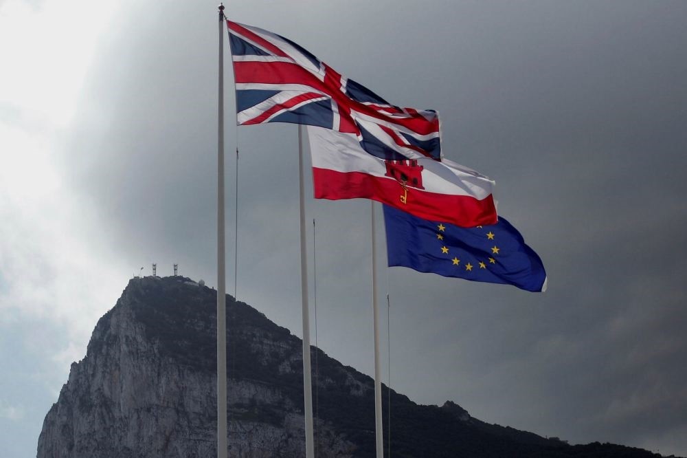 The United Kingdom flag, the Gibraltarian flag and the European Union flag are seen flying at the border of Gibraltar with Spain.