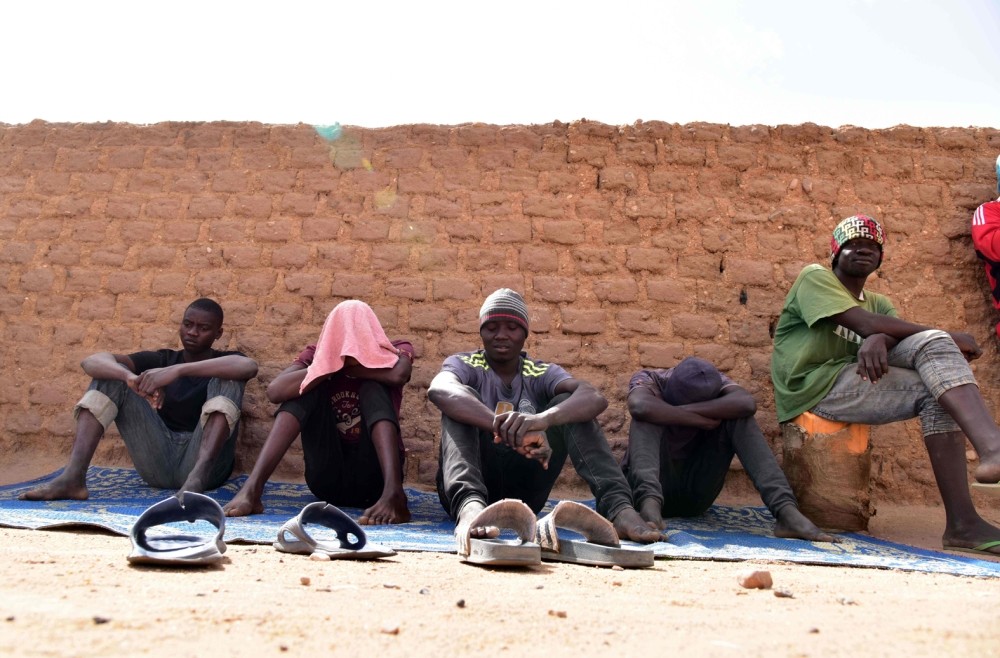 Migrants from West Africa waiting in a room at a u201cghettou201d in Agadez, northern Niger, as they wait to go to Libya from where they will attempt to reach Europe by  crossing the Mediterranean sea.