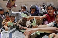 Yemeni children present documents to receive food (AP File Photo)