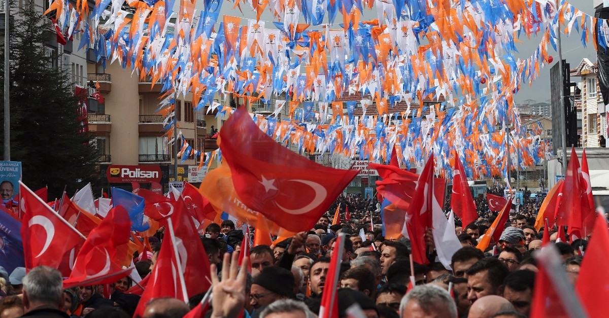 People wave flags as they gather to listen to President Erdou011fan during a campaign rally for the upcoming March 31 elections, Ankara, March 13, 2019. 