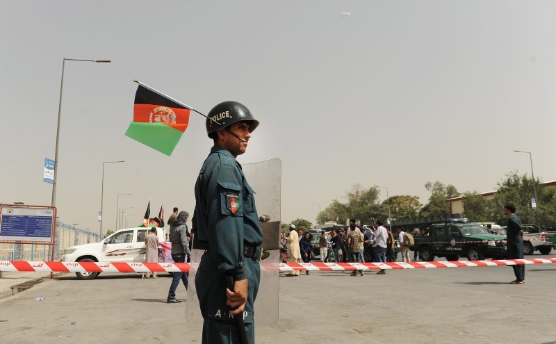 An Afghan police officer stands guard during a gathering of civil society activists urging the government to secure Ghazni province in downtown Kabul, Afghanistan, 13 August 2018. (EPA Photo)