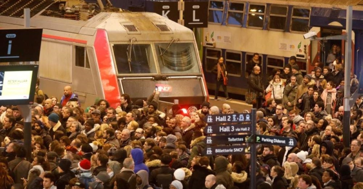 Commuters walk to take a train at Gare de Lyon train station during a strike by all unions of French SNCF workers and the Paris transport network (RATP) in Paris. (Reuters Photo)