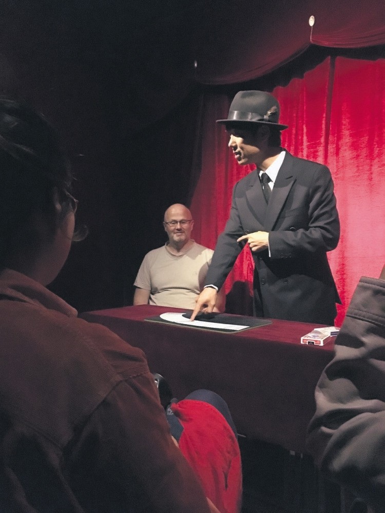 A magician taking stage at Magic Lamp.