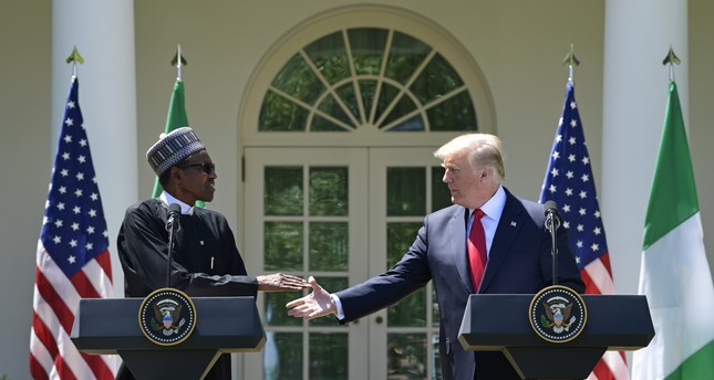 President Donald Trump, right, reaches out to shake hands with Nigerian President Muhammadu Buhari, left, during a news conference in the Rose Garden of the White House in Washington, Monday, April 30, 2018. (AP Photo)