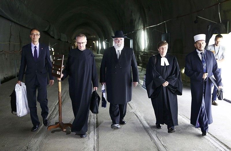 Chief of the Security Division of the Federal Office of Transport Pieter Zeilstra, Father Martin Werlen, Rabbi Marcel Yair Ebel, Reverend Simona Rauch and Imam Bekim Alimi (L-R) arrive for benediction of the NEAT Gotthard Base Tunnel. (Reuters Photo)