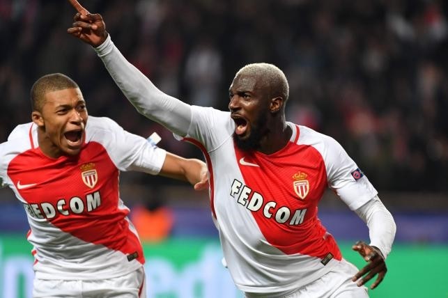 Monaco's French midfielder Tiemoue Bakayoko celebrates with Monaco's French forward Kylian Mbappe Lottin (L) after scoring a goal during the UEFA Champions League round of 16 football match.