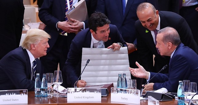 U.S. President Donald Trump, Interpreter Emrah Kale, President Recep Tayyip Erdoğan and Foreign Minister Mevlüt Çavuşoğlu talk during the working session at the G20 leaders summit in Hamburg, Germany, July 7, 2017. (Reuters Photo)