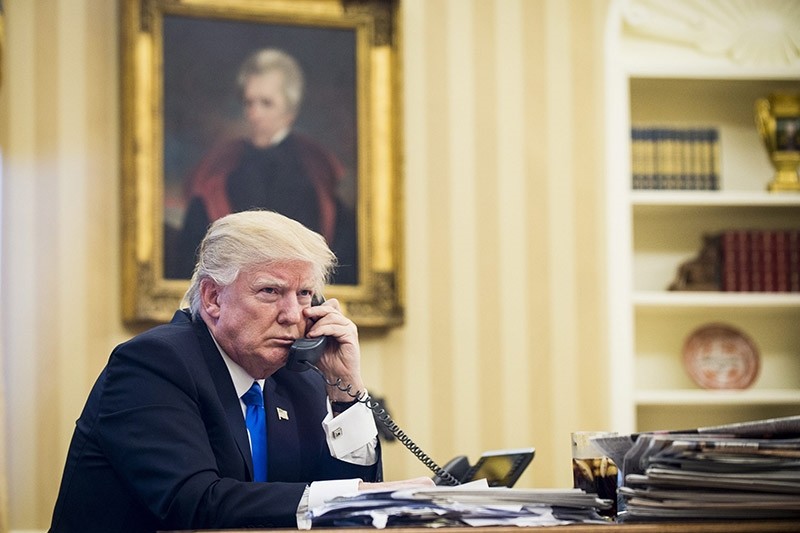  US President Donald J. Trump speaks on the phone with Prime Minister of Australia, Malcolm Turnbull, in the Oval Office in Washington (EPA Photo)