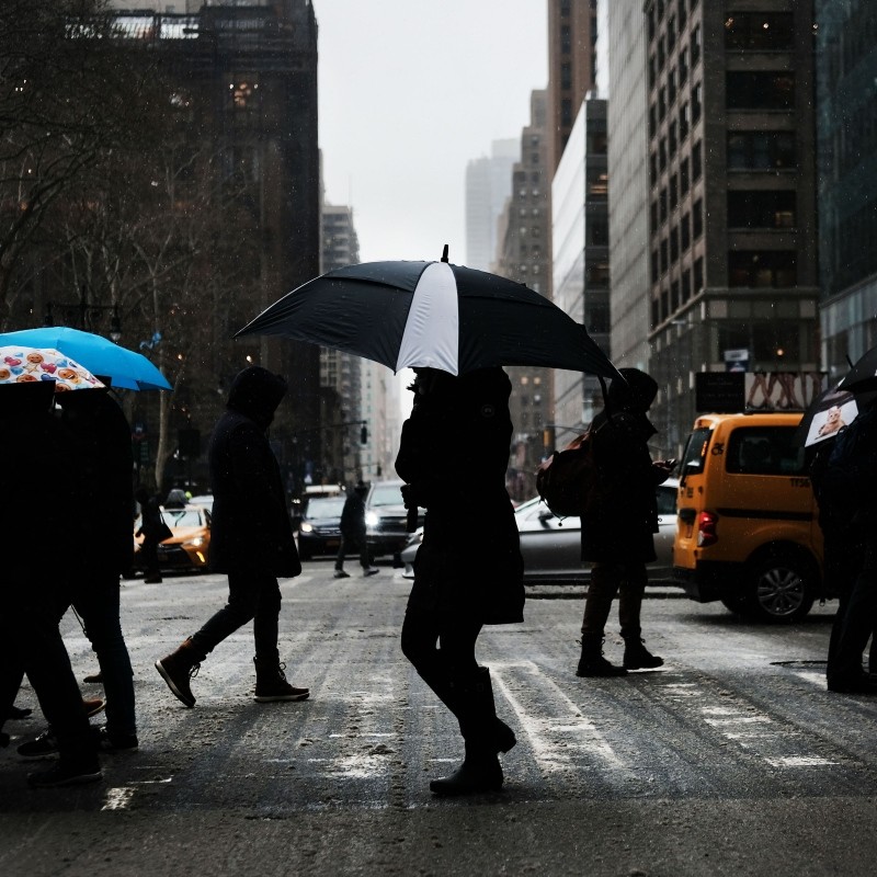 People walk through the snow and sleet in Manhattan, New York, Feb. 12, 2019. (AFP Photo)