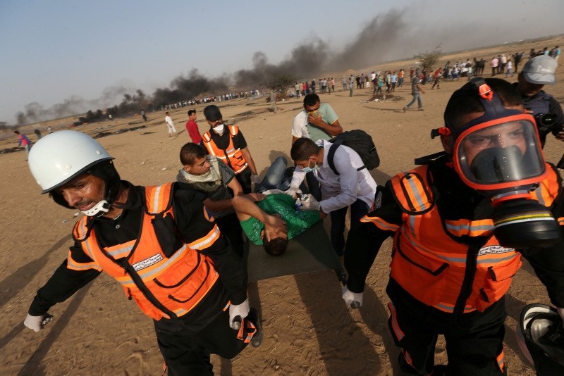 A wounded demonstrator is evacuated during a protest where Palestinians demand the right to return to their homeland, at the Israel-Gaza border, in the southern Gaza Strip May 18, 2018. (Reuters Photo)