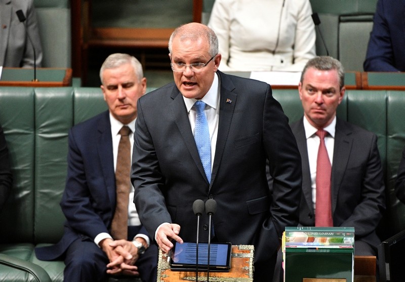 Australian PM Scott Morrison, center, delivers a formal apology to Australia's victims of child sex abuse in the House of Representatives at Parliament House in Canberra, Monday, Oct. 22, 2018. (AP Photo)