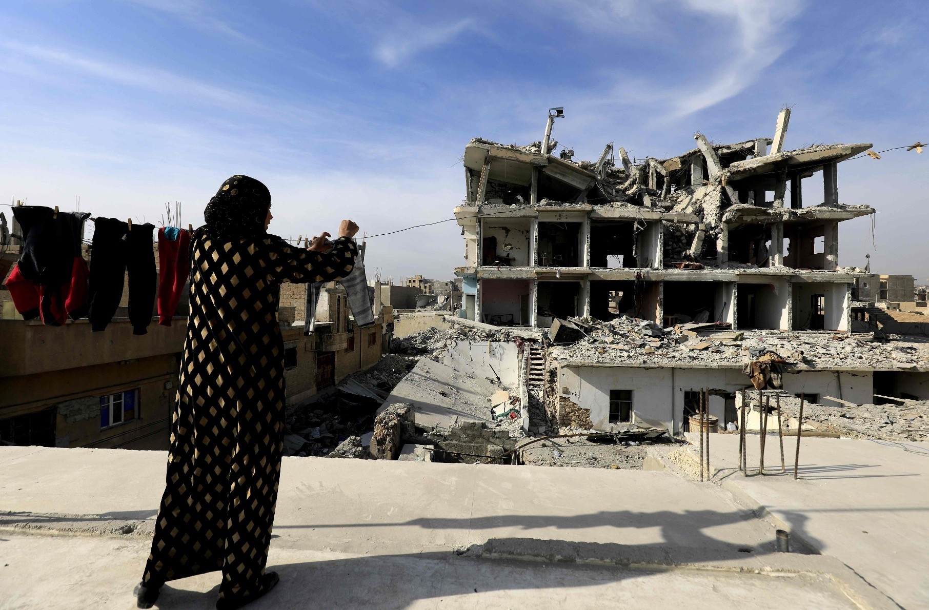 A woman hangs laundry in Raqqa, Syria, Jan. 11.