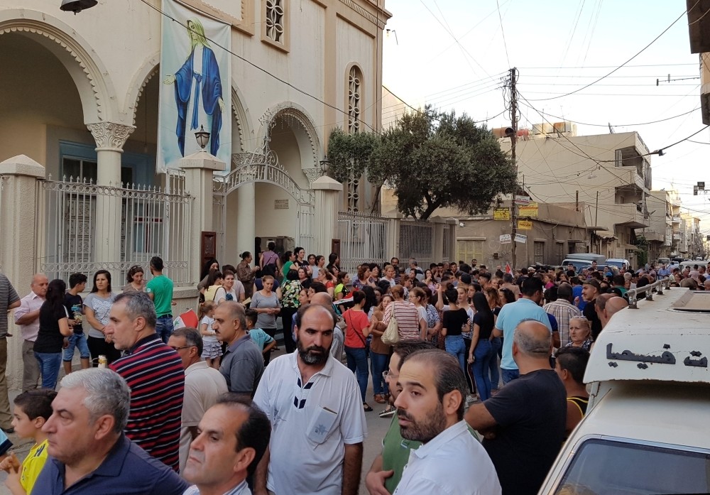 Christians came together in the Qamishli town center, demanding the reopening of their schools. 