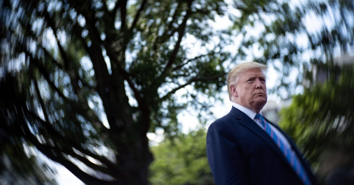 US President Donald Trump speaks to the press while walking to Marine One on the South Lawn of the White House, on August 2, 2019, in Washington, DC. (AFP Photo)