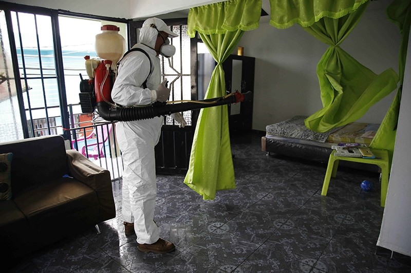 A health worker sprays insecticide inside the home of a woman diagnosed with the Zika virus in Acacias, Colombia, Thursday, Feb. 4, 2016 (AP Photo)
