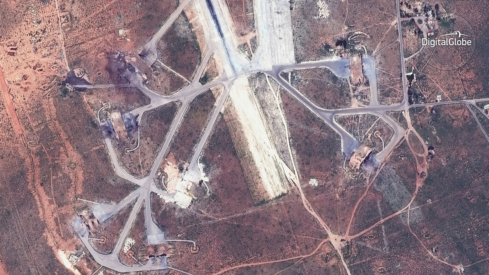 Image captured on April 7 of destroyed aircraft shelters on the southeast side of the Shayrat air base in Syria. (DigitalGlobe via AP)