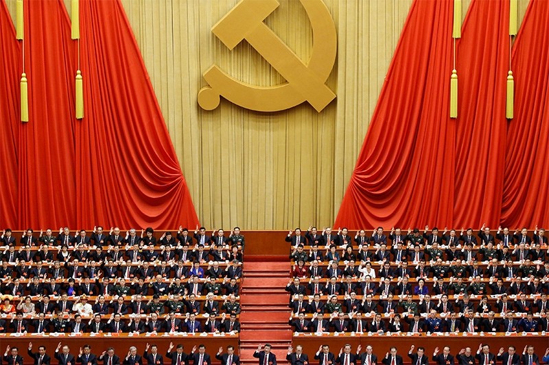 Chinese President Xi Jinping (front row, center) and fellow delegates raise their hands as they take a vote at the closing session of the 19th National Congress of the Communist Party of China, in Beijing (Reuters Photo)