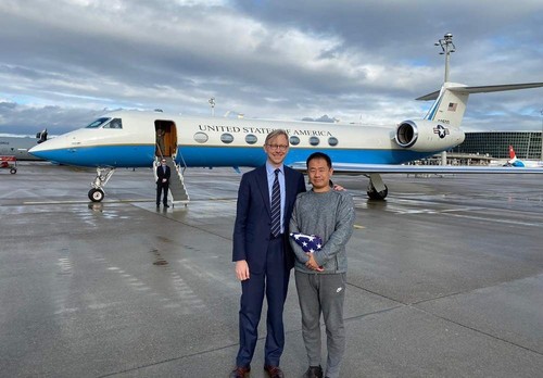 U.S. special representative for Iran Brian Hook stands with Xiyue Wang in Zurich, Switzerland on Dec. 7, 2019. (U.S. State Department via AP)