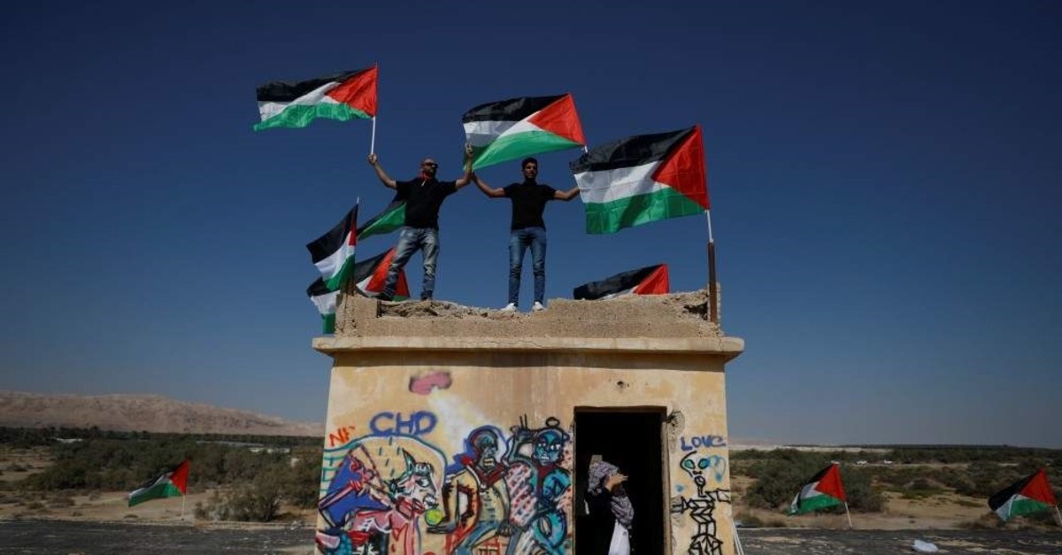 Demonstrators hold Palestinian flags near the Dead Sea in the occupied West Bank, Sept. 28, 2019. (REUTERS Photo)