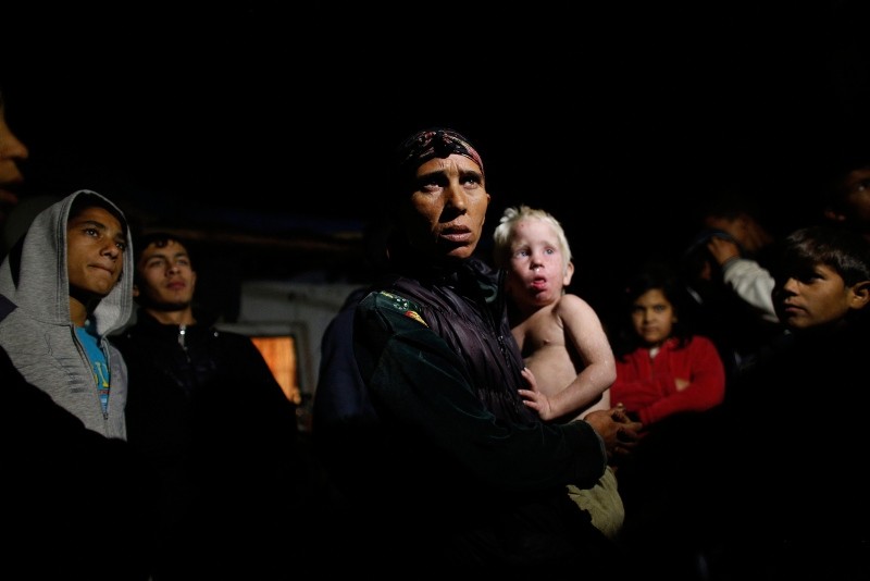 Bulgarian Roma woman holds her son as she speaks to media outside her house in the town of Nikolaevo, some 280 km (173 miles) east of Sofia, Bulgaria, Oct. 24, 2013. (Reuters Photo)